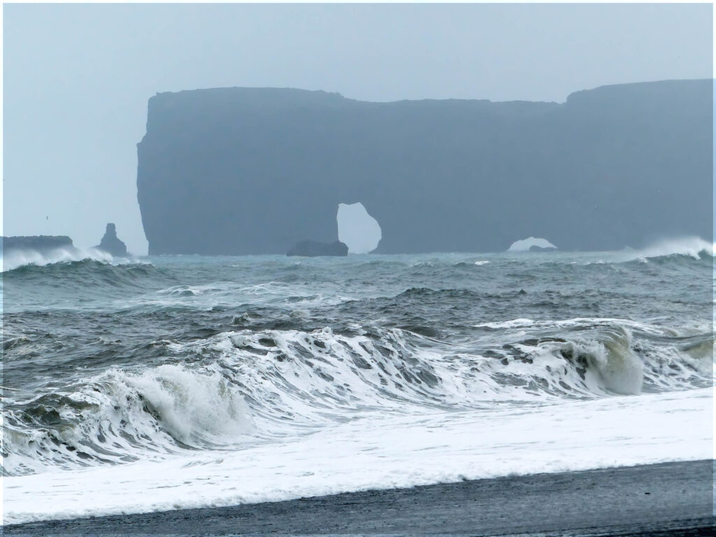 Misty cliffs with rock arch